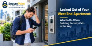 Man locked out of his West End apartment, checking his phone beside a building intercom and fob entry panel